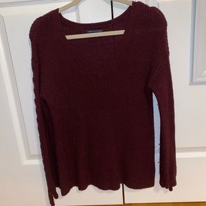 Maroon sweater criss crossed arms